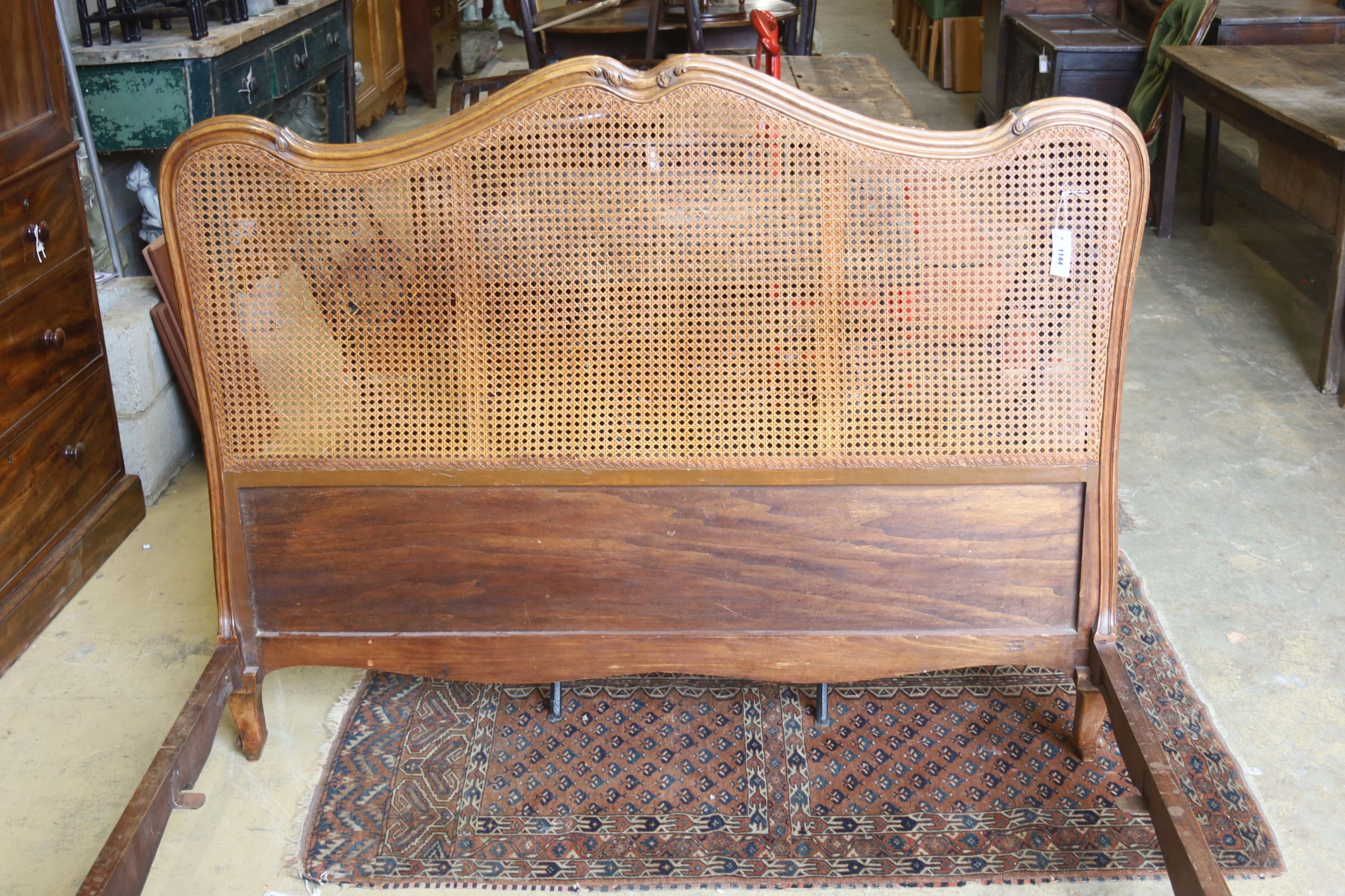 A late 19th / early 20th century French caned walnut double bedframe, width 150cm, length 210cm